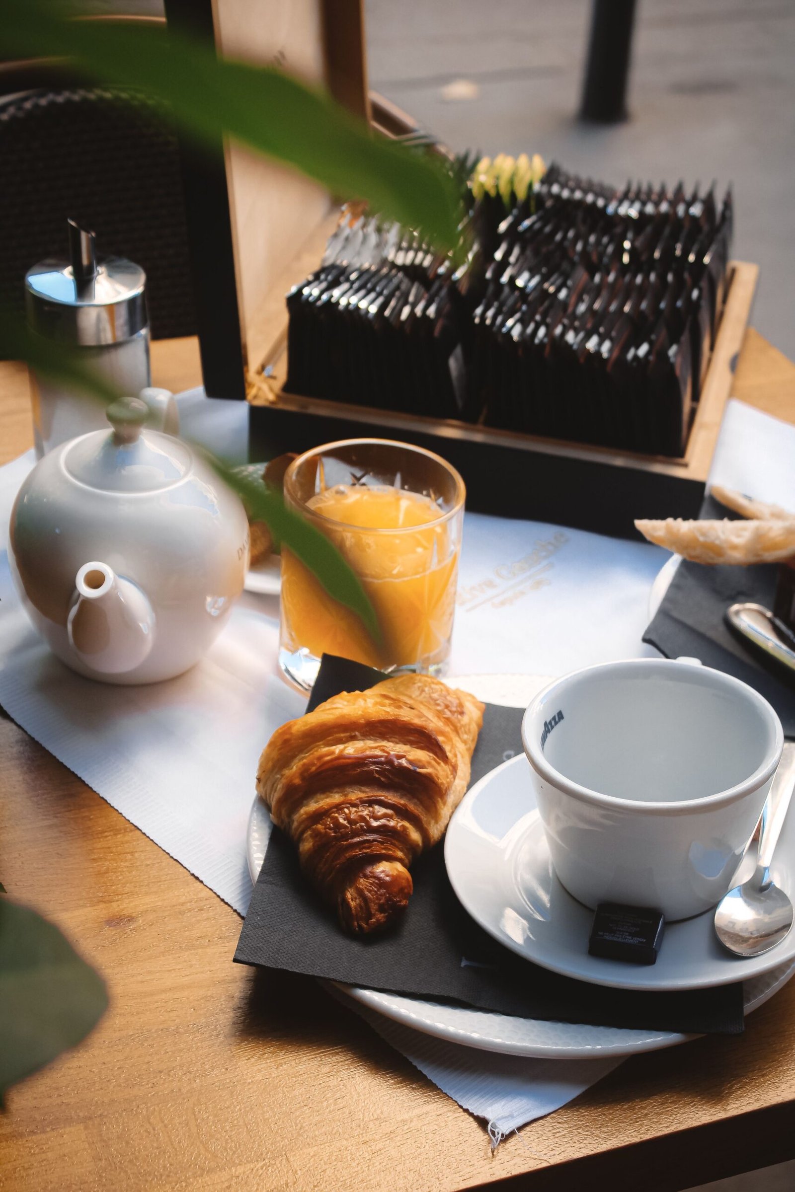 GÎTE ET CHAMBRE Delight in a traditional French breakfast with croissant, coffee, and juice in Lyon.
